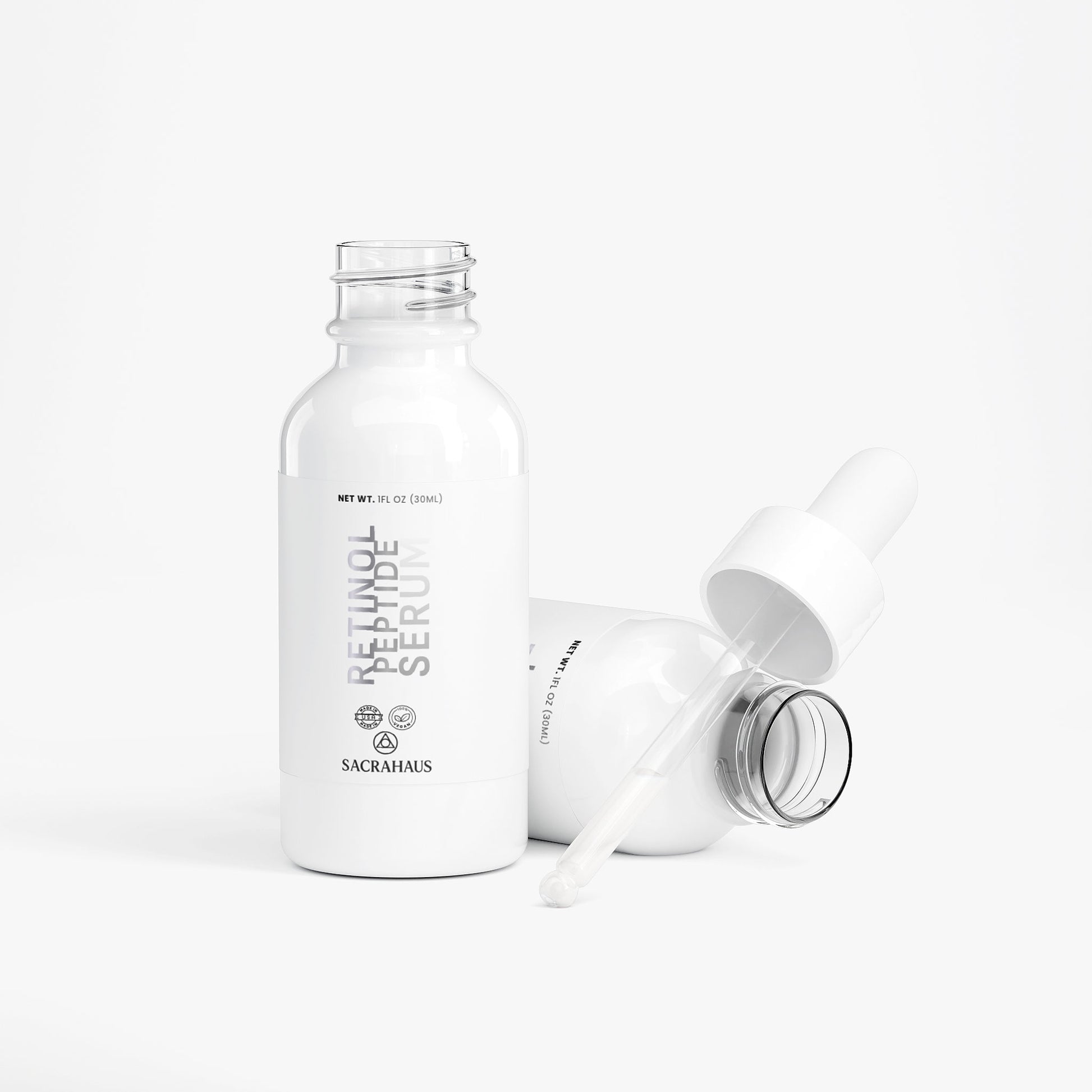 SACRAHAUS retinol peptide face serum in white bottle with dropper for anti-aging skincare