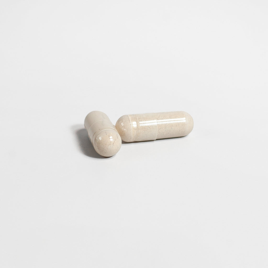 SACRAHAUS vegan energy supplement capsules in light color on a white background