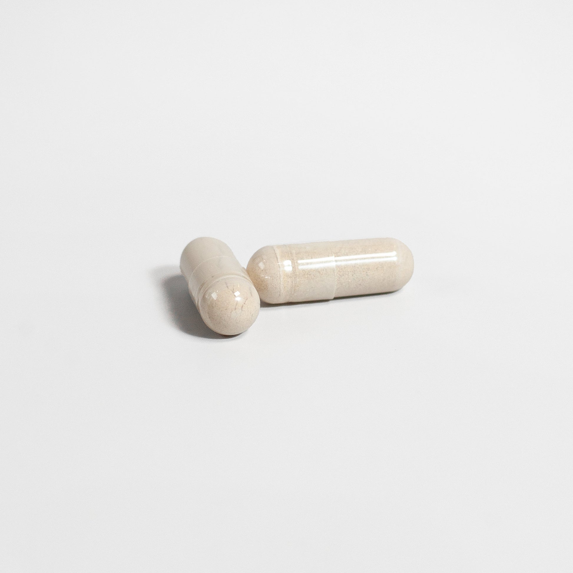 SACRAHAUS vegan energy supplement capsules in light color on a white background