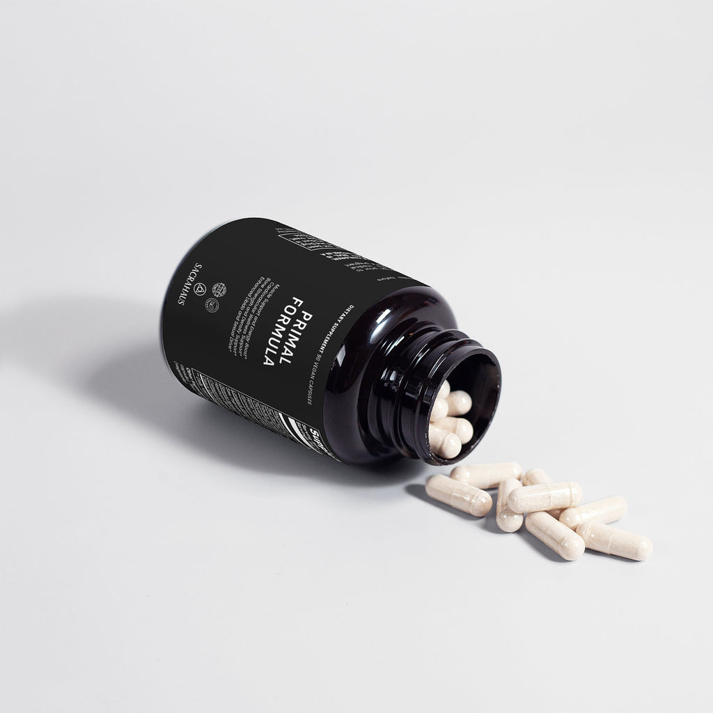 SACRAHAUS vegan energy supplement bottle with spilled capsules for wellness and vitality